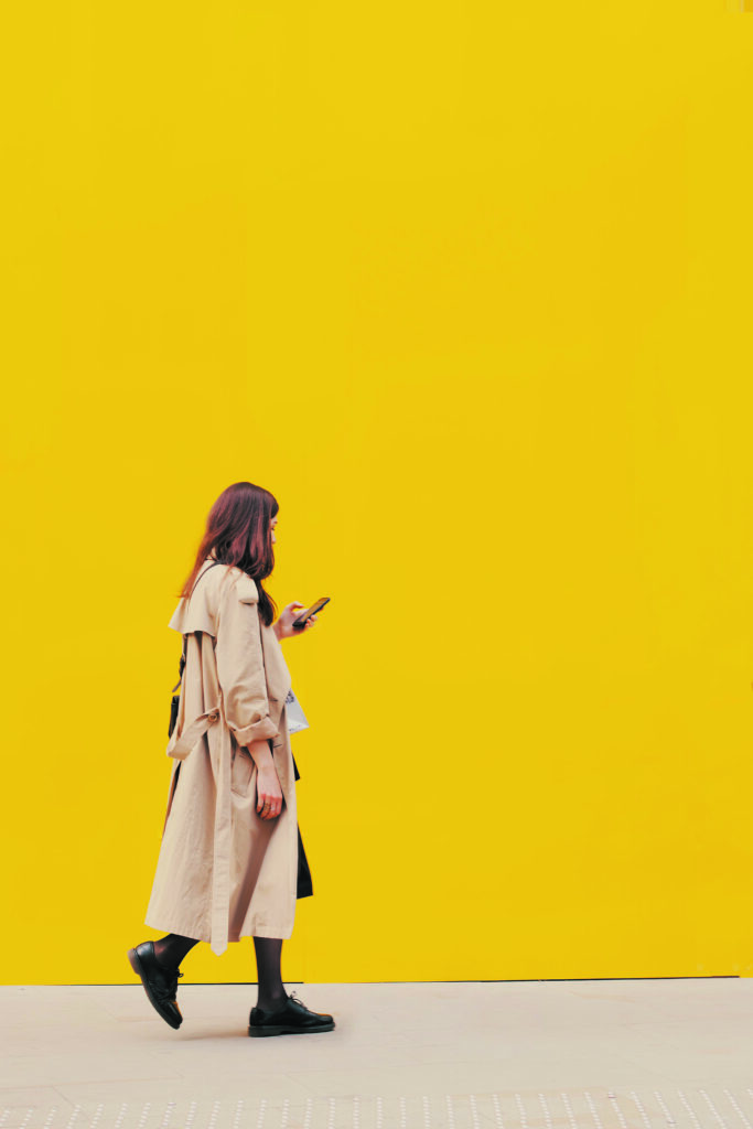 Femme avec un imperméable qui marche